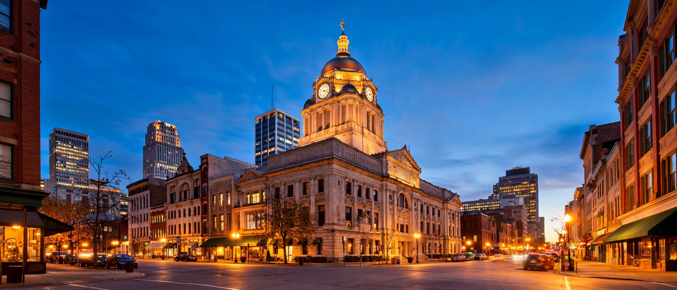 Downtown Fort Wayne, Indiana at dusk, with the Allen County Courthouse lit against the evening sky